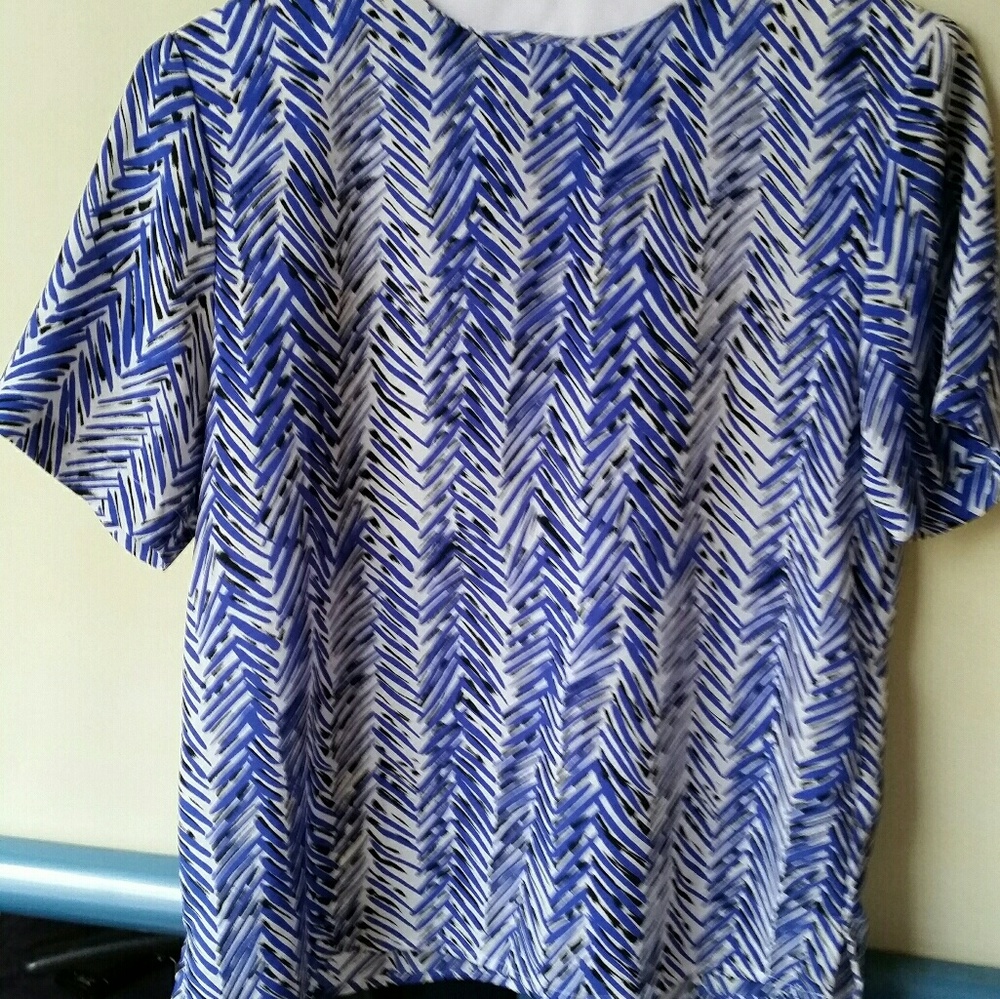 Blue, black, white patterned blouse. Button back.